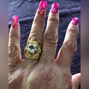 Gold tone ring with large crystal accent